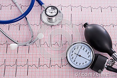 Sphygmomanometer with aneroid gauge and stethoscope with Electrocardiogram paper. Stock Photo