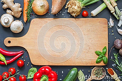 Spice herbs and vegetables food background and empty cutting board Stock Photo