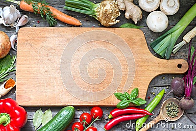 Spice herbs and vegetables food background and empty cutting board Stock Photo