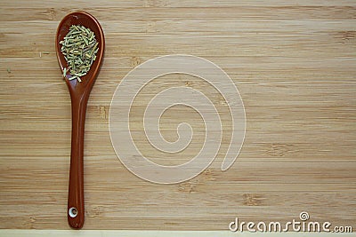 Spice rosemary in a ceramic spoon Stock Photo