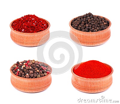 Spice selection of paprika, mixed spice, cayenne pepper, and allspice ground in wooden bowl, isolated on white Stock Photo