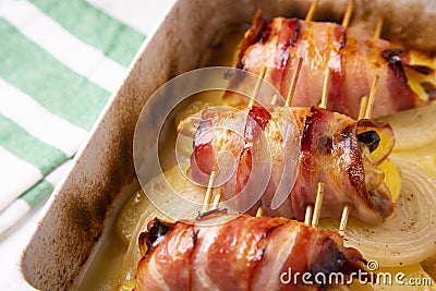 Spiced chicken rolled with bacon cooked in the oven. Stock Photo