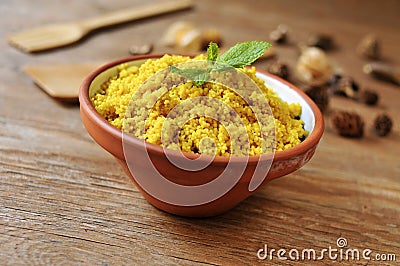 Spiced couscous on a rustic wooden table Stock Photo