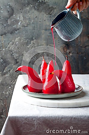 Spiced hibiscus or red wine poached pears. Delicious winter french dessert. Stock Photo