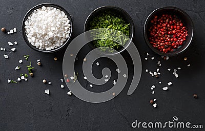 Diverse spices in plates on dark background, closeup, copy space Stock Photo