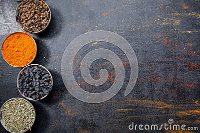 Spices. Colorful spices. Curry, Saffron, turmeric, cinnamon and otheron a dark concrete background. Pepper. Large collection of di Stock Photo