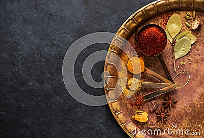 Spices and herbs in measuring spoons Stock Photo