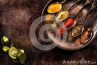 Spices and herbs in spoons Stock Photo