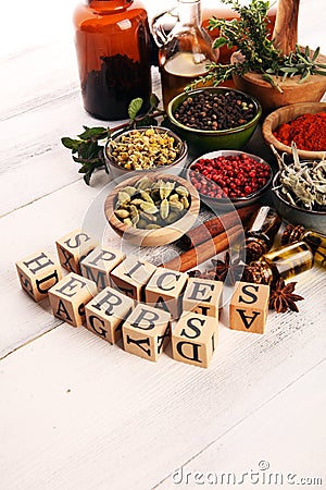 Spices and herbs on table. Food and cuisine ingredients with pepper and spices herbs sign with wooden cubes Stock Photo