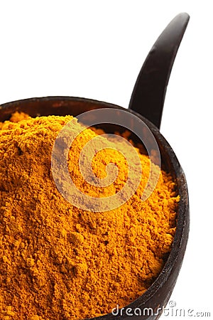 Spices - pile of bright yellow ground turmeric Stock Photo