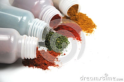 Spices spilling out of jars Stock Photo