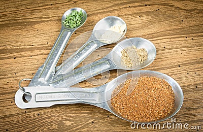 Spices In Spoons On Wooden Background Stock Photo