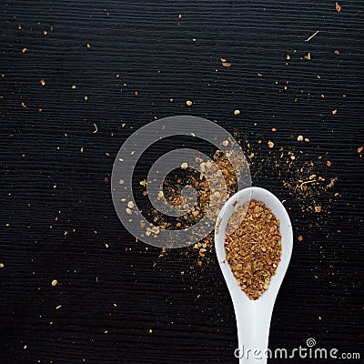 Spices were scattered on black wooden table. Measuring spoon. Cooking and seasoning for taste Stock Photo