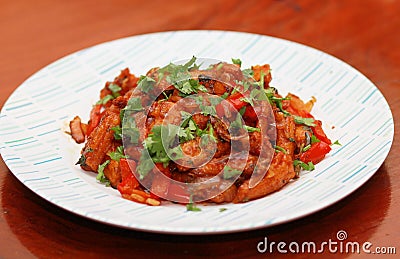 Spicy Babycorn Manchurian with tomato sauce and mixed with Capsicum, Coriander leaf Stock Photo