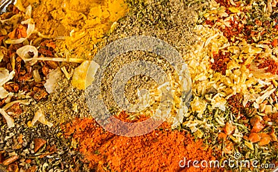 Spicy background with a variety of hot chili pepper, curry, pepper and a mixture of other spices. Copy space Stock Photo