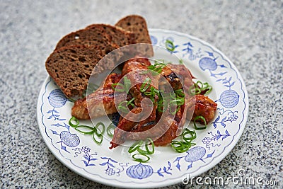 Spicy barbecue chicken buffalo wings marinated and served with whole grain bread. Stock Photo