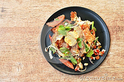 Spicy batter fried egg slice with chop chicken meat Thai salad on plate Stock Photo