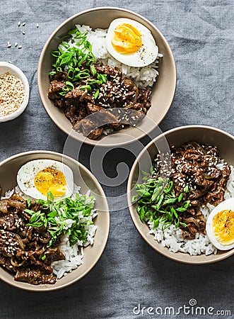 Spicy beef, rice and boiled egg bowl on grey background, top view. Asian food concept Stock Photo