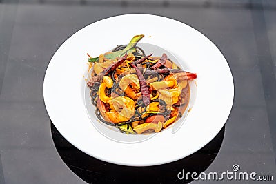 spicy black spaghetti with shrimps (tom yum kung Stock Photo