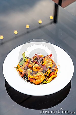 spicy black spaghetti with shrimps (tom yum kung Stock Photo