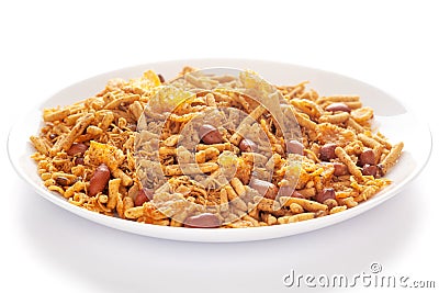 Spicy Chatpata Mixture in a white ceramic plate made with peanuts, corn flakes, Stock Photo