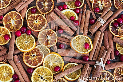 Spicy Christmas background. Cinnamon, oranges and cranberry. Stock Photo