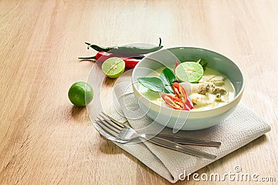 Spicy creamy coconut soup with chicken , Thai food called Tom Kha Gai on the wooden table Stock Photo