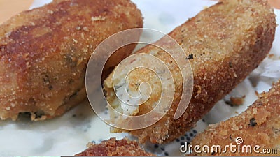 Spicy and delicious croquettes served in ceramic plate over wooden floor Stock Photo