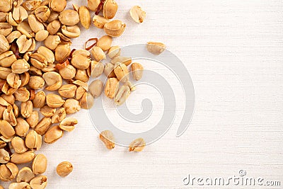 Spicy flavored peanut kernel spilling on white table background Stock Photo