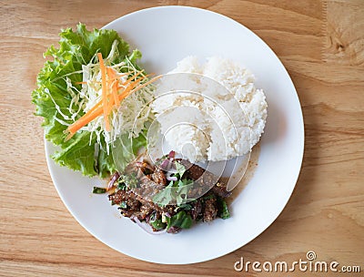 Spicy fried pork rice on the table wood. Stock Photo