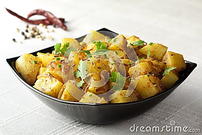 Spicy fried potaoes with roasted cumin seeds Stock Photo