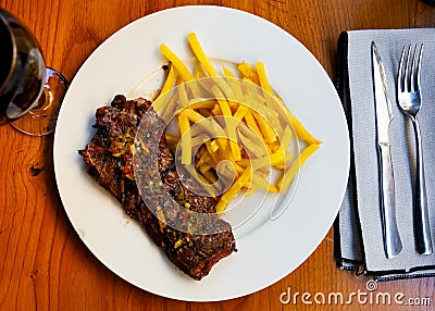Spicy grilled veal tenderloin with French fries Stock Photo