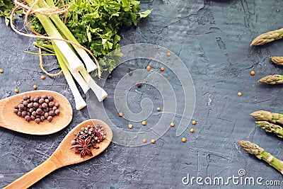 Spicy herbs, asparagus, lemons, seasonings, lentils on the kitchen table Stock Photo