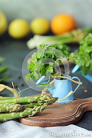 Spicy herbs, asparagus, lemons, seasonings, lentils on the kitchen table for preparing healthy homemade food Stock Photo