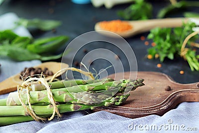 Spicy herbs, asparagus, lemons, seasonings, lentils on the kitchen table Stock Photo