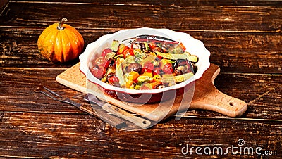 Spicy hot vegetables, cooked on an grill in ceramic bowl on wooden background. The concept of healthy eating and delicious food. Stock Photo