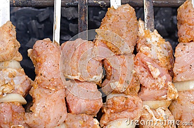 Spicy kebabs grilling over a barbecue Stock Photo