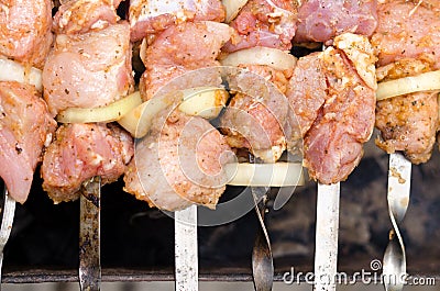 Spicy kebabs grilling over a barbecue Stock Photo