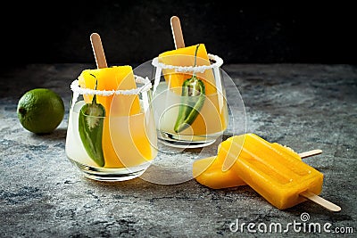 Spicy mango popsicle margarita cocktail with jalapeno and lime. Mexican alcoholic drink for Cinco de mayo party. Stock Photo