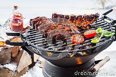 Spicy marinated spare ribs grilling outdoors Stock Photo