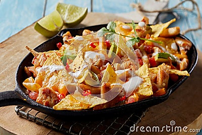 Spicy Mexican chicken with nachos and cream Stock Photo