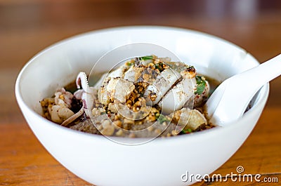 Spicy Noodle in a white bowl on wooden background. The favorite Stock Photo