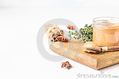 Spicy pear jam in glass jar, fresh pears, spices cinnamon and anise and thyme. Stock Photo