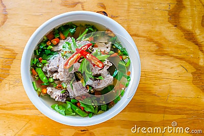 Spicy Pork with Pork bone Soup on the Wood Table. Stock Photo