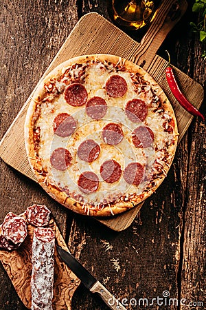 Spicy salami or pepperoni pizza with chili Stock Photo