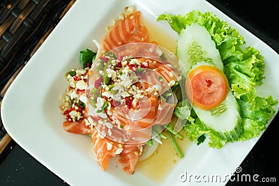 Spicy Salmon Salad with fresh chilli and garlic, Thai food style. Home made food. Concept for a tasty and healthy meal, top view Stock Photo