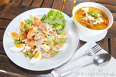 Spicy seafood Thai-style salad with Tom Yum Goong Stock Photo