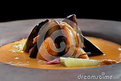 Spicy soup of mashed potatoes with mussels from the pumpkin with greens-2. Stock Photo