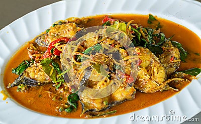 Spicy stir-fried fish with pepper, chili and thai herbs. stir fried fish with thai herbs, spicy local food, the unique spice of Th Stock Photo