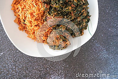 Spicy Tasty Nigerian Jollof with Vegetable Soup Stock Photo